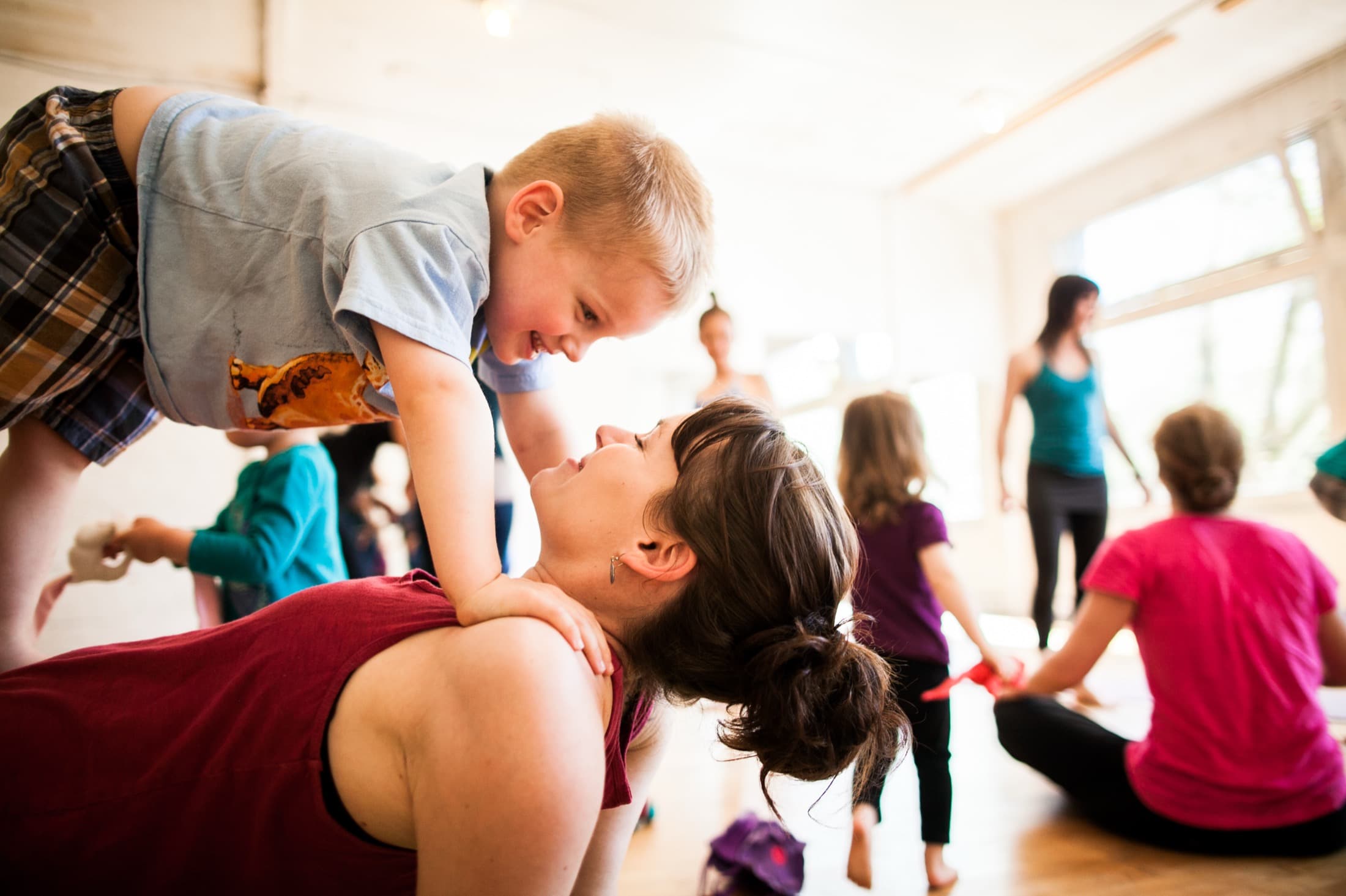 Child and adult enjoying a Rainbow Yoga partner moment