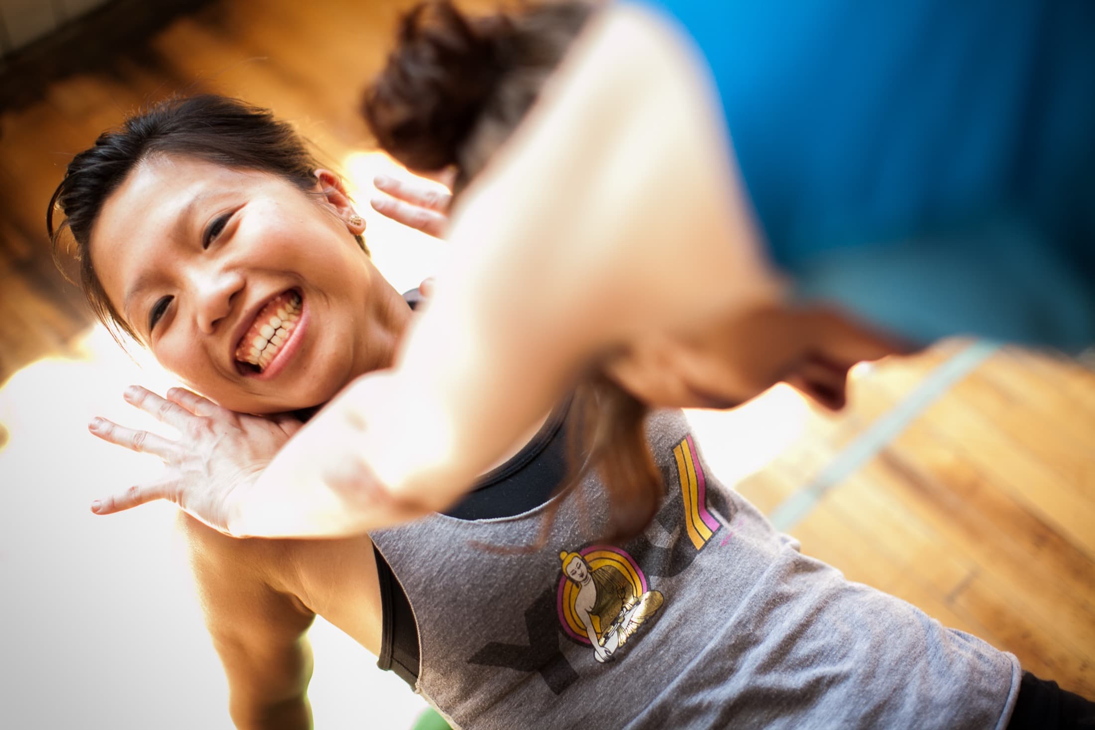 Child smiling during a playful Rainbow Yoga pose